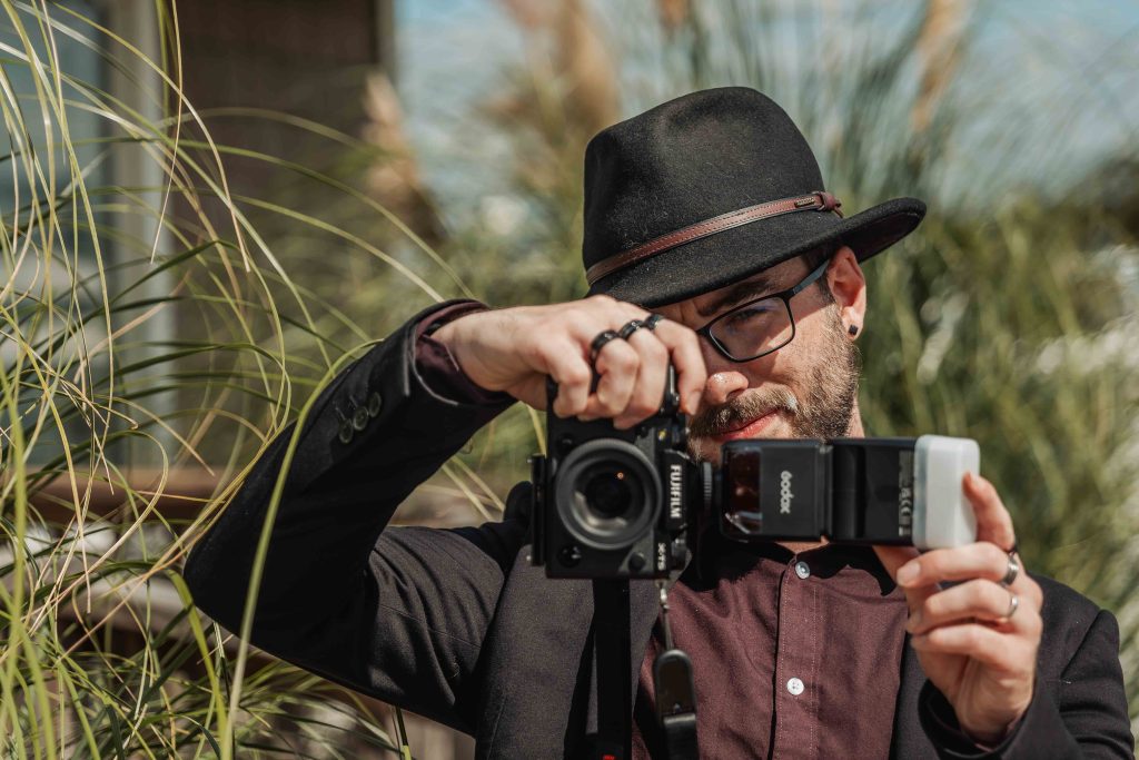 Erik behind his camera, photographing outdoors